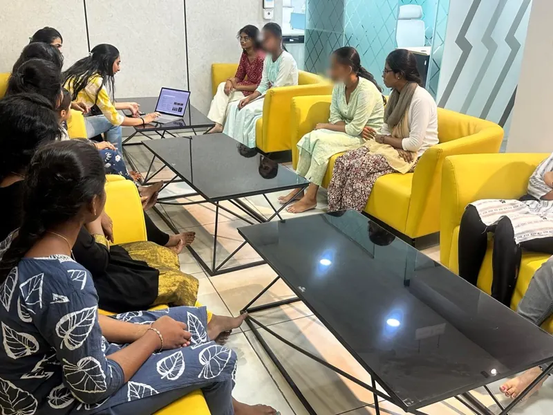 Common area with yellow sofas and glass table